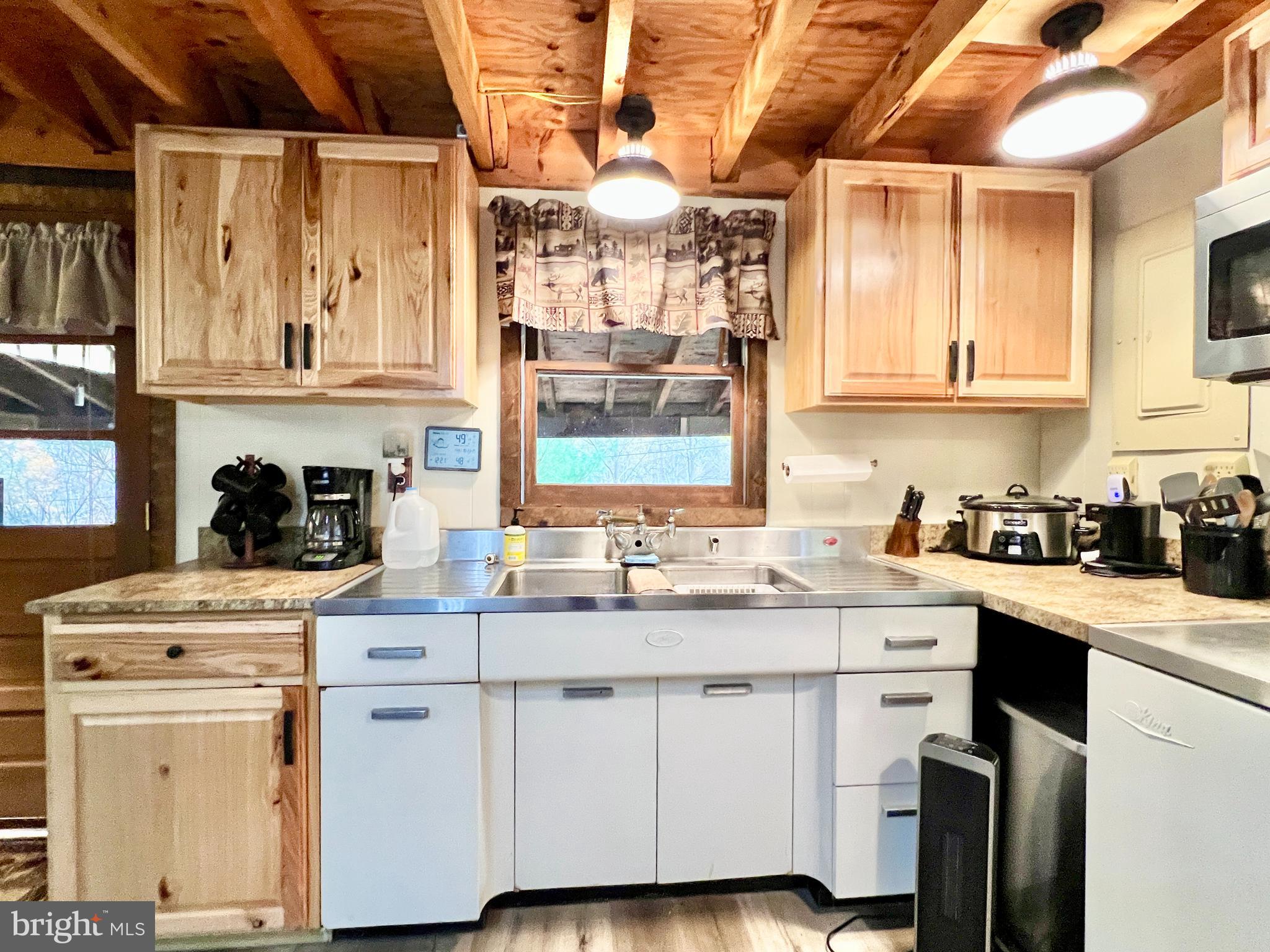 1858 Sandy Run Road Hopewell, PA 16650 - Photo 14 of 35 a kitchen with a stove window and cabinets