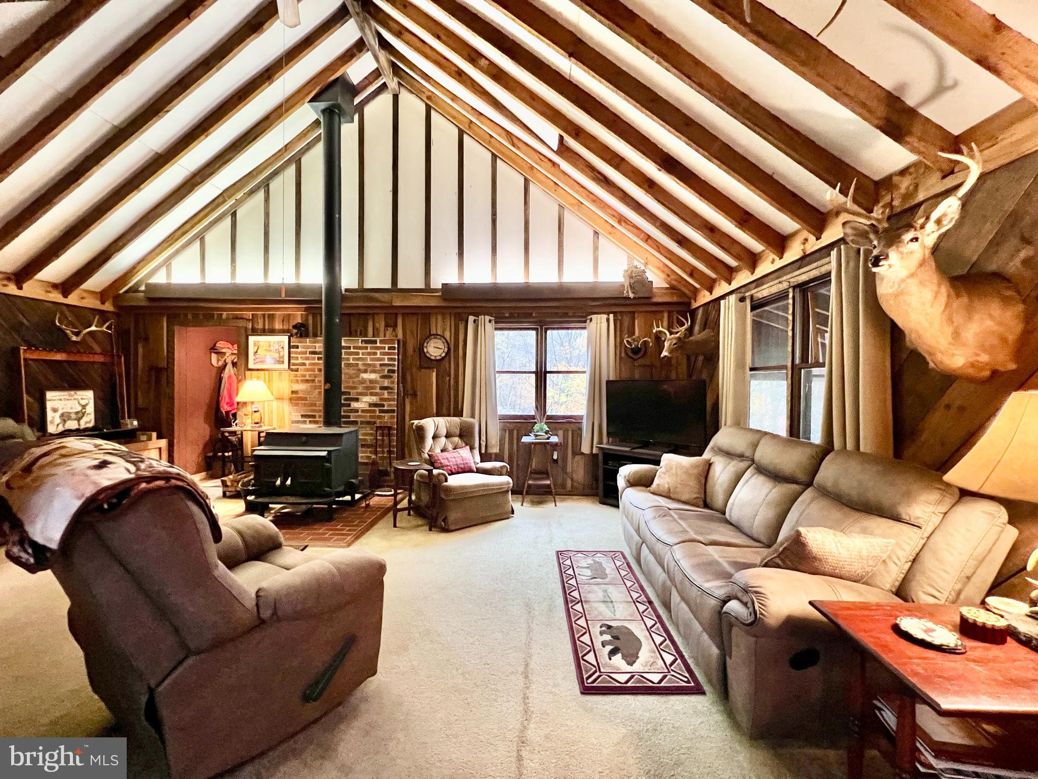 1858 Sandy Run Road Hopewell, PA 16650 - Photo 16 of 35 a living room with furniture a couch and large windows
