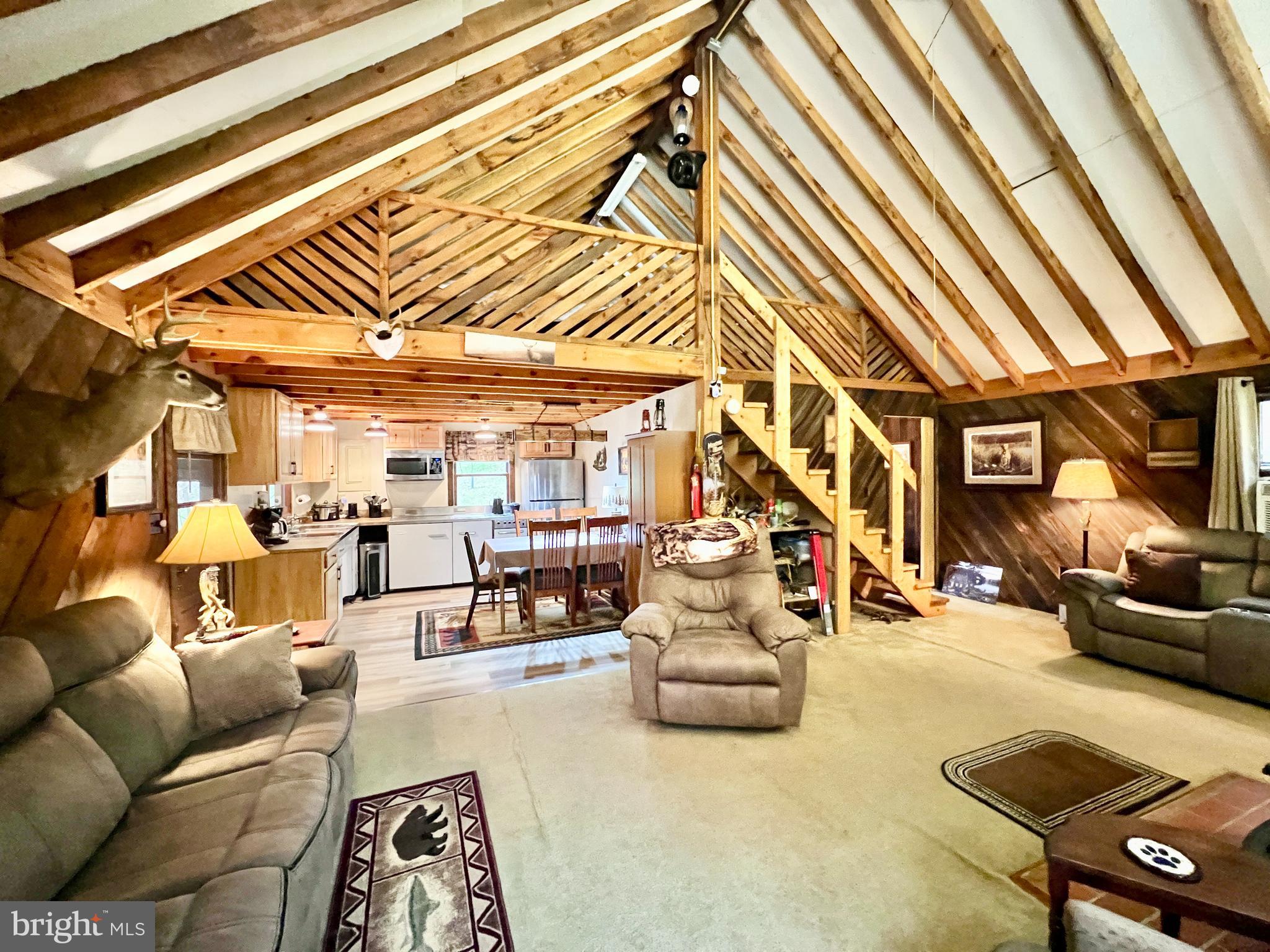 1858 Sandy Run Road Hopewell, PA 16650 - Photo 17 of 35 a living room with furniture and a chandelier