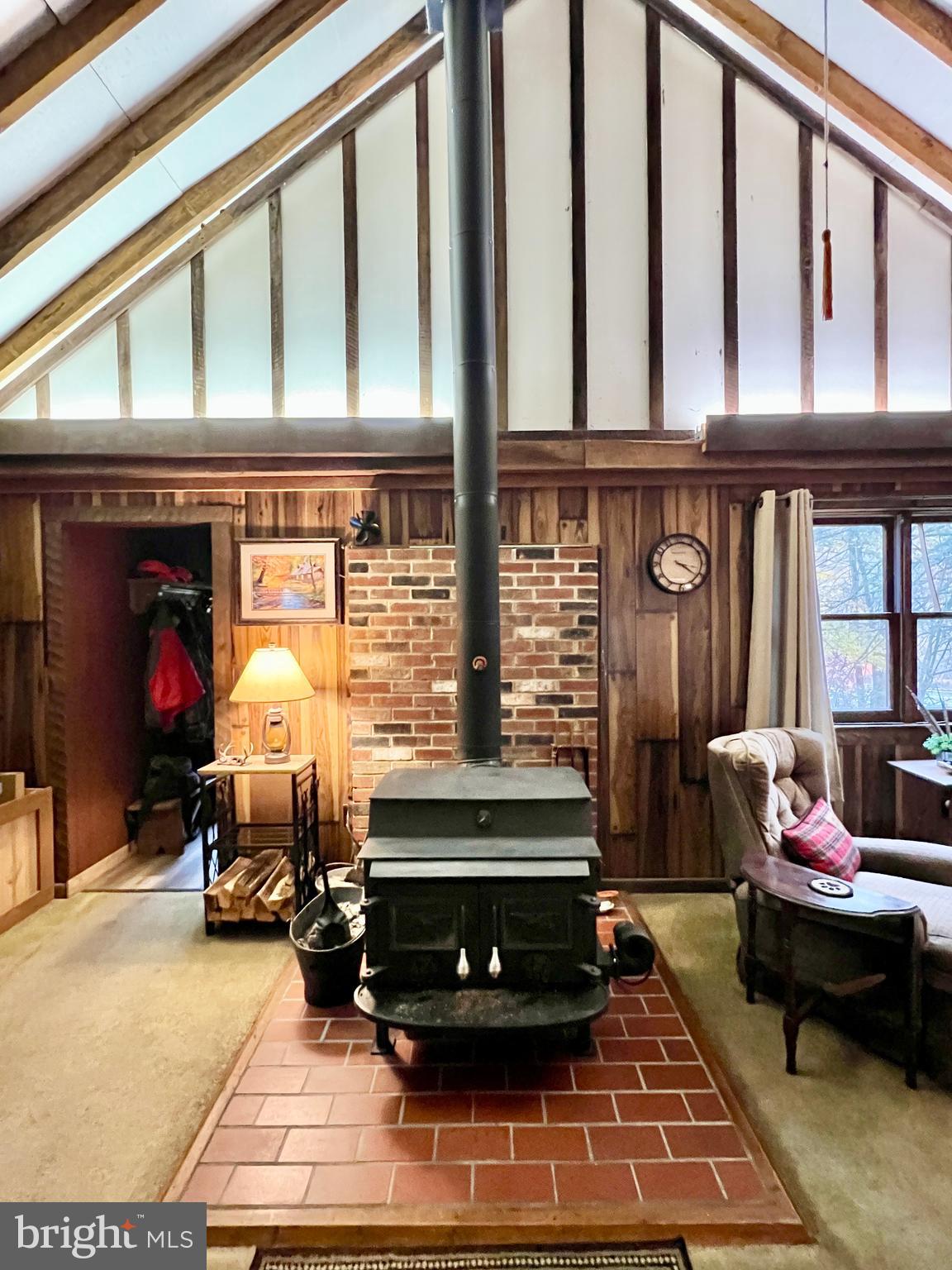1858 Sandy Run Road Hopewell, PA 16650 - Photo 20 of 35 a living room with furniture a fireplace and gym equipment
