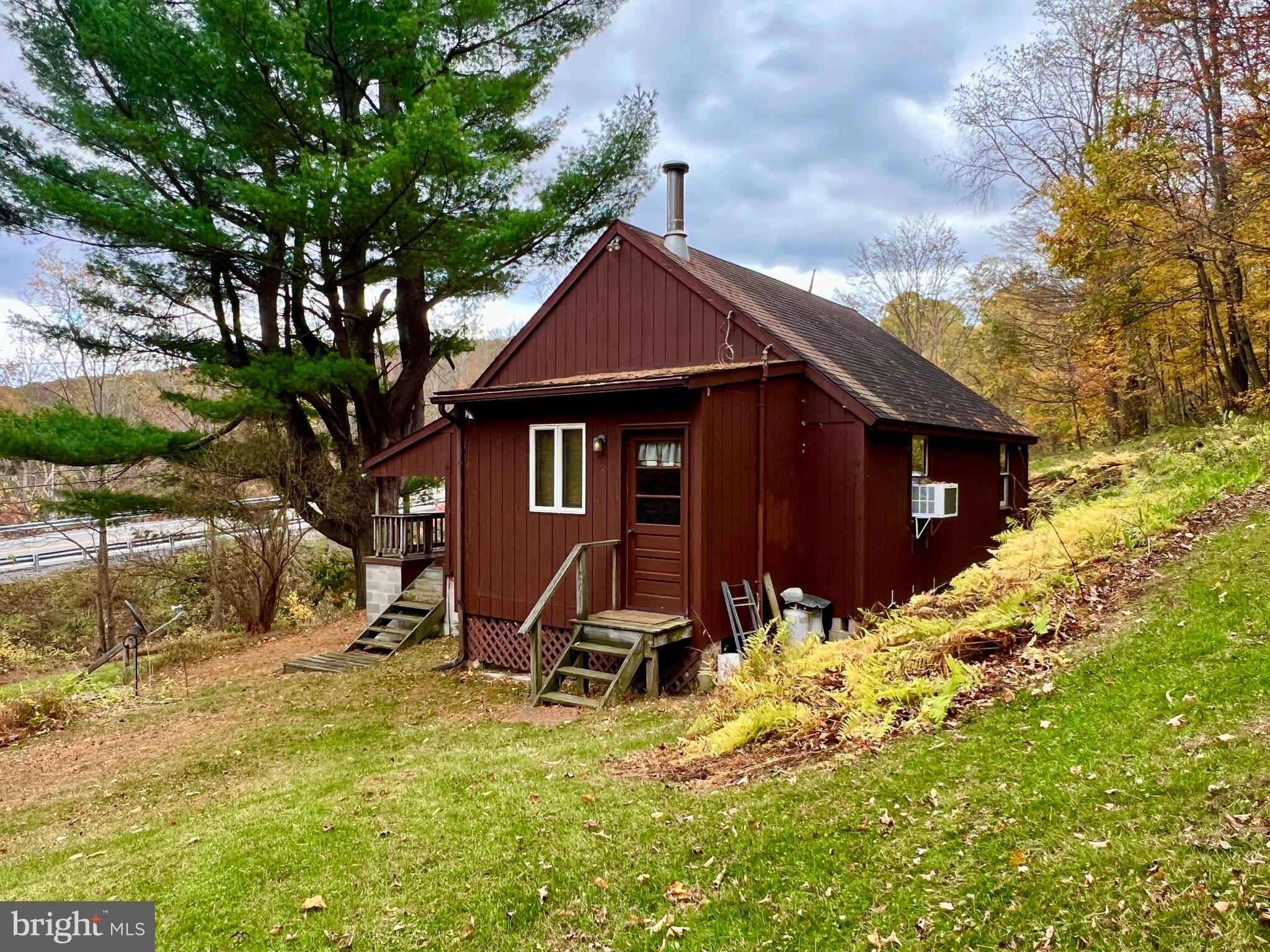 1858 Sandy Run Road Hopewell, PA 16650 - Photo 6 of 35 a view of wooden house with a yard