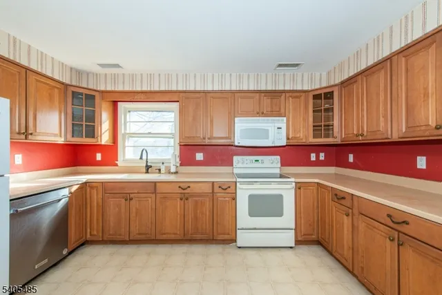a kitchen with a sink stove top oven and cabinets
