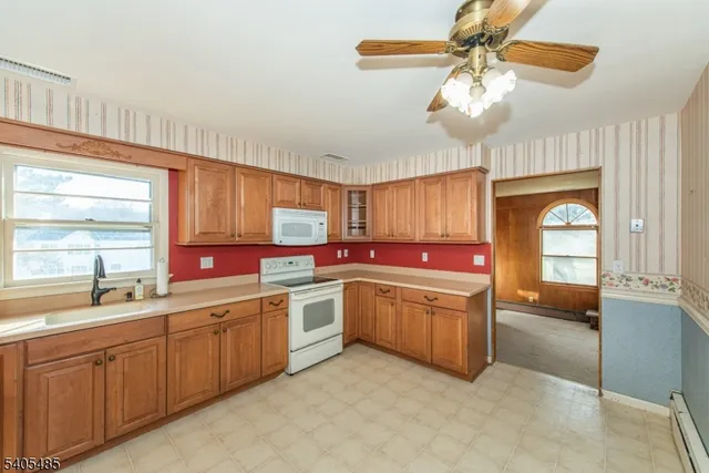 a kitchen with cabinets a sink and appliances