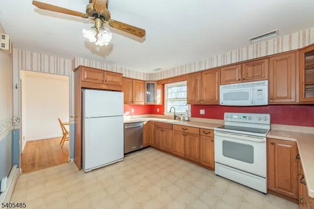 a kitchen with refrigerator cabinets and window