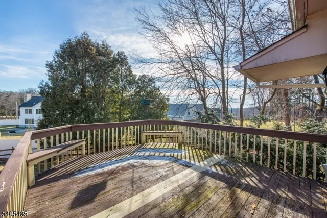 a view of balcony with wooden floor and fence