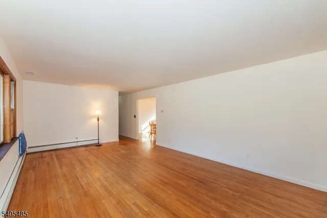 a view of an empty room and wooden floor