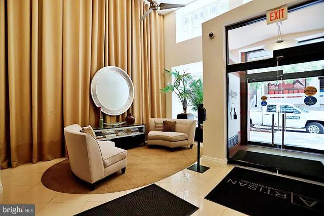 a living room with furniture a rug and a window