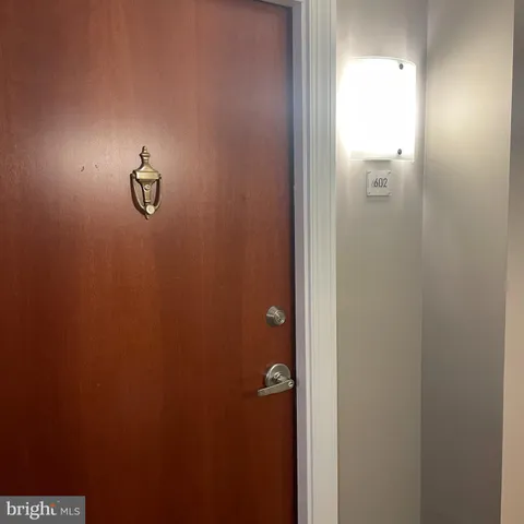 a kitchen with a refrigerator and a stove top oven