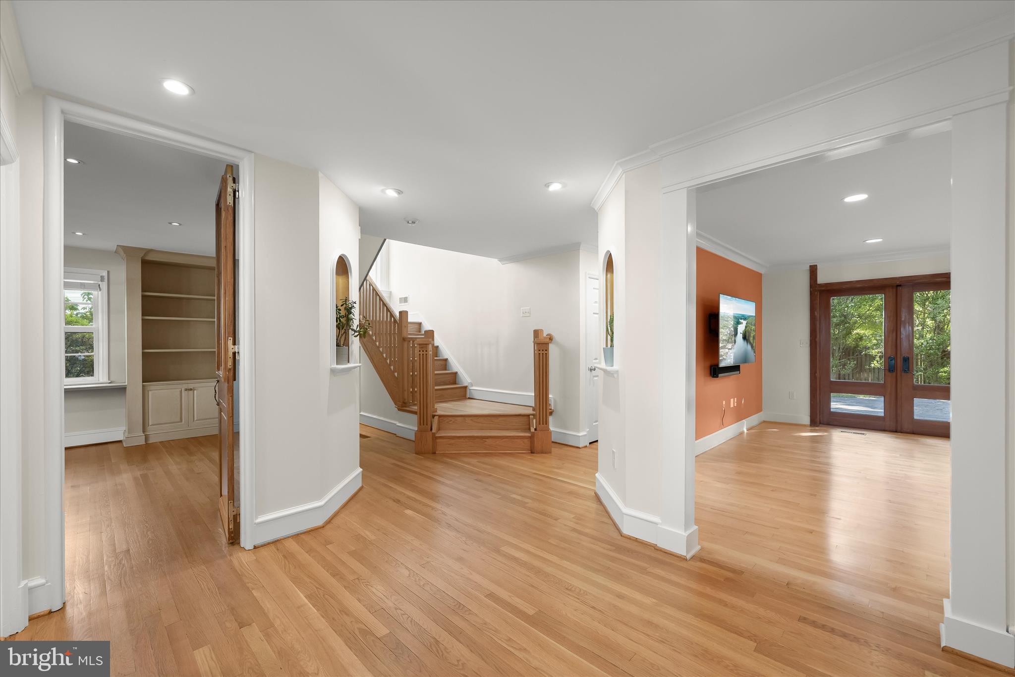 5104 Scarsdale Road Bethesda, MD 20816 - Photo 4 of 68 a view of an entryway with wooden floor and a kitchen