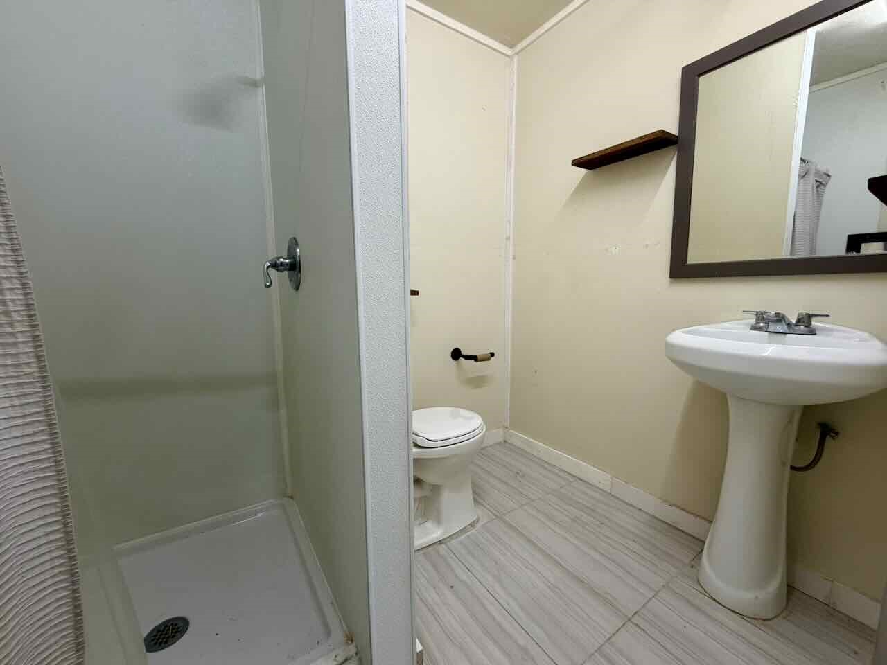 3844 South Pine Island Road Beaumont, TX 77713 - Photo 19 of 24 a bathroom with a sink toilet and shower