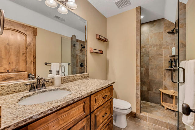 9049 Timphaven Road Sundance, UT 84604 - Photo 33 of 63 Full bathroom with vanity, a stall shower, and light tile patterned floors