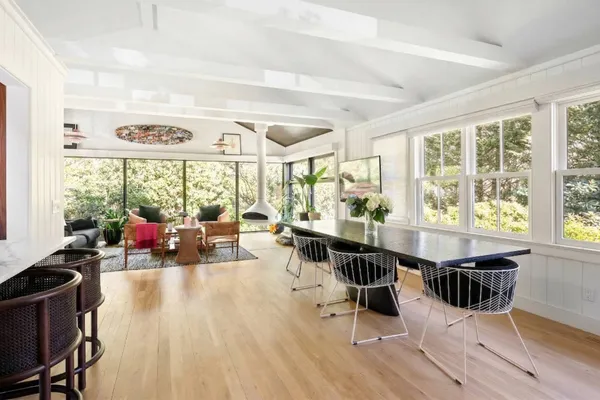 a living room with furniture and large windows
