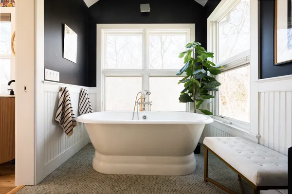 a bathroom with a bathtub and window