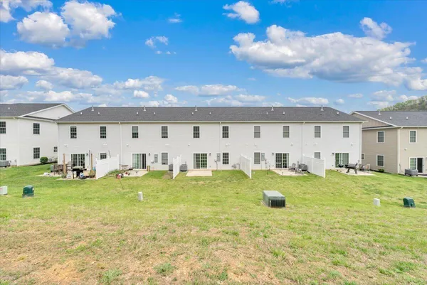a view of a house with a backyard