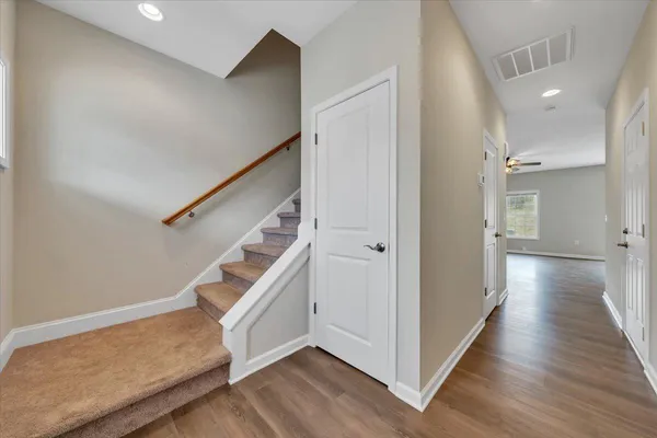 a view of an entryway with wooden floor and stairs