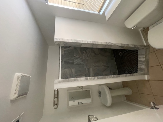 3411 Lyons Road Austin, TX 78702 - Photo 4 of 12 a bathroom with a toilet and a shower