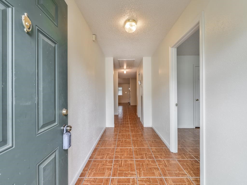 15522 Blake Way Street Houston, TX 77032 - Photo 2 of 19 a view of a hallway with wooden floor and a bathroom