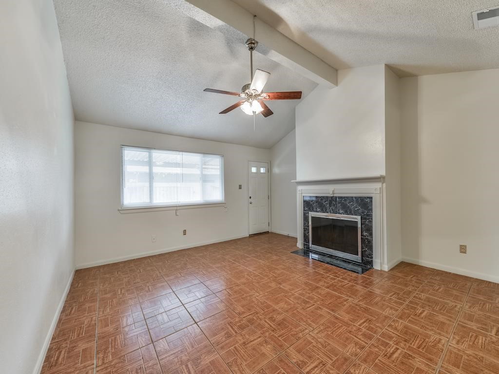 15522 Blake Way Street Houston, TX 77032 - Photo 4 of 19 an empty room with windows and fireplace