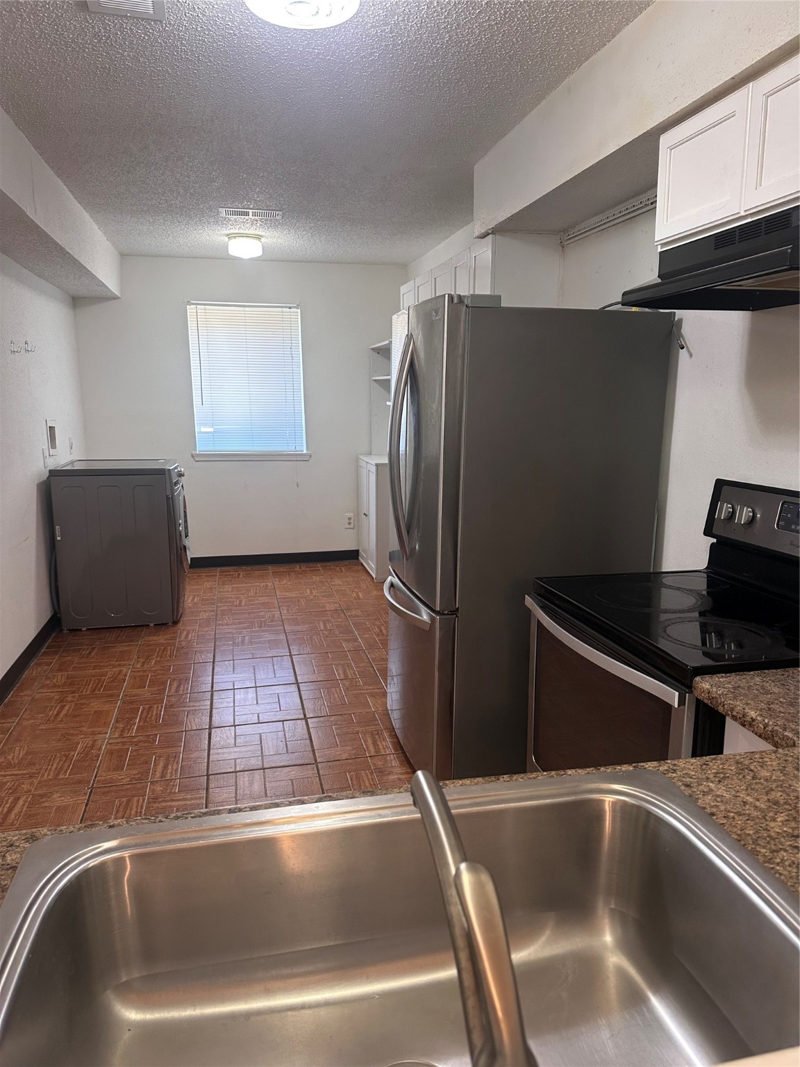 15522 Blake Way Street Houston, TX 77032 - Photo 6 of 19 a view of a kitchen with a sink and refrigerator