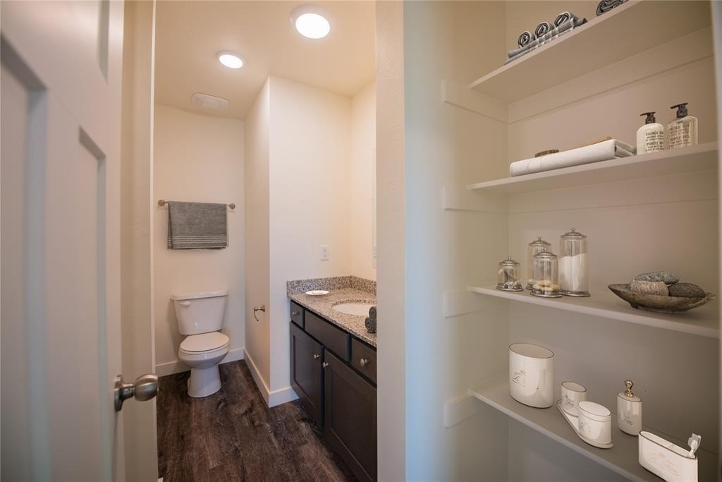12603 Telge Road, Unit 7D Cypress, TX 77429 - Photo 7 of 19 a bathroom with a granite countertop toilet sink and mirror