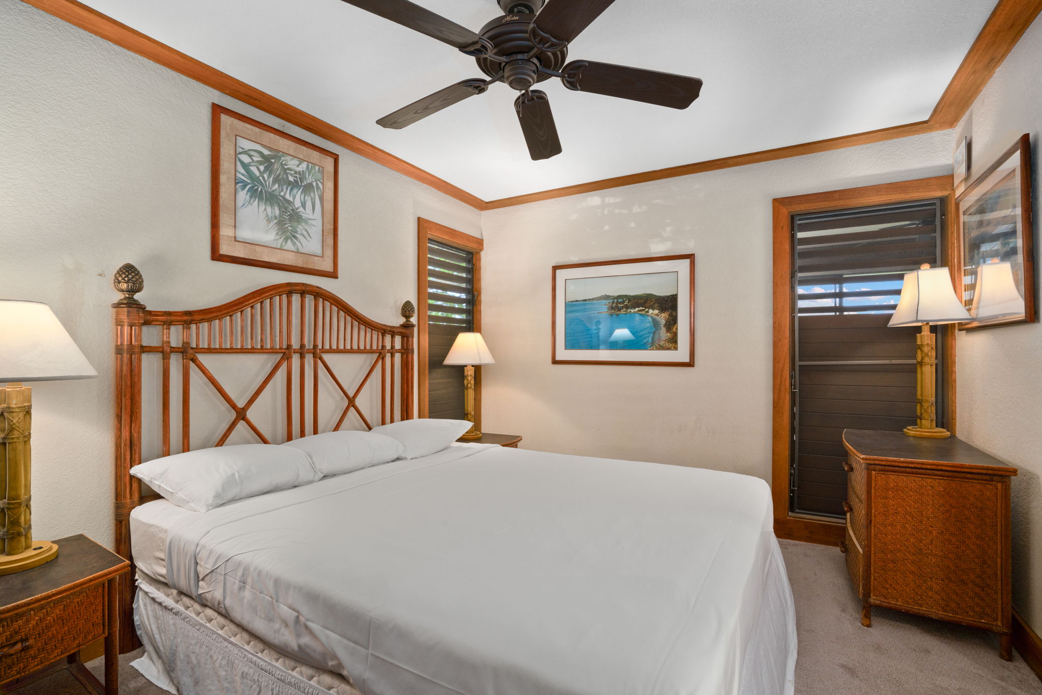 2253 Poipu Road, Unit 330 Koloa, HI 96756 - Photo 14 of 26 a bedroom with a bed and a chandelier