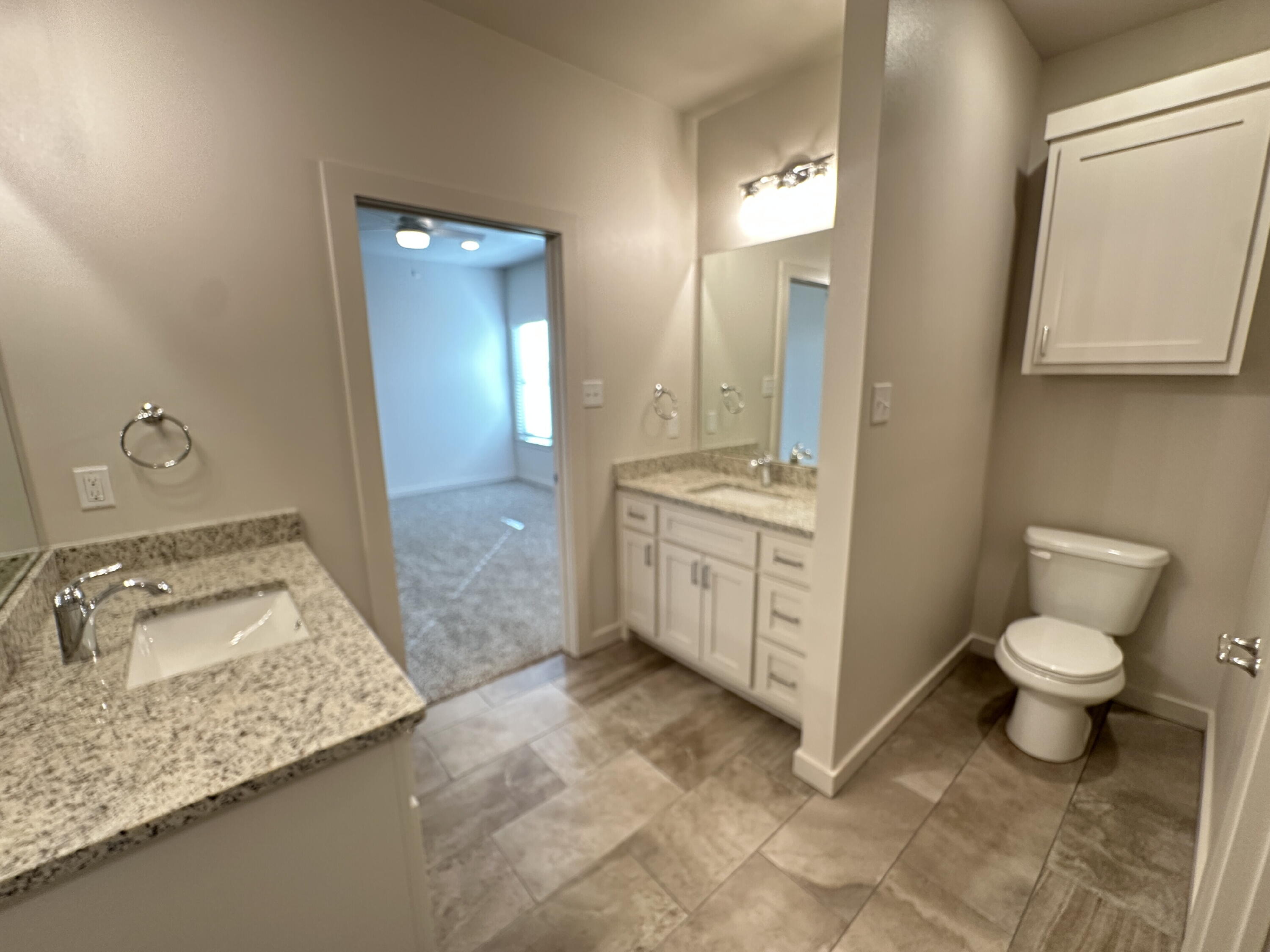 1113 North 7th Street Wolfforth, TX 79382 - Photo 13 of 17 a bathroom with a sink a toilet and mirror