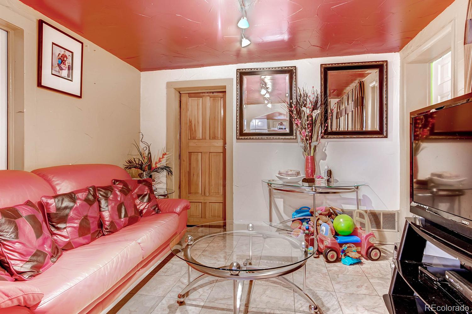 125 Inca Street Denver, CO 80223 - Photo 1 of 1 a bedroom with a bed a couch and dresser