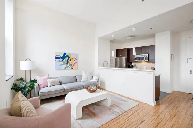 a living room with furniture and flowers
