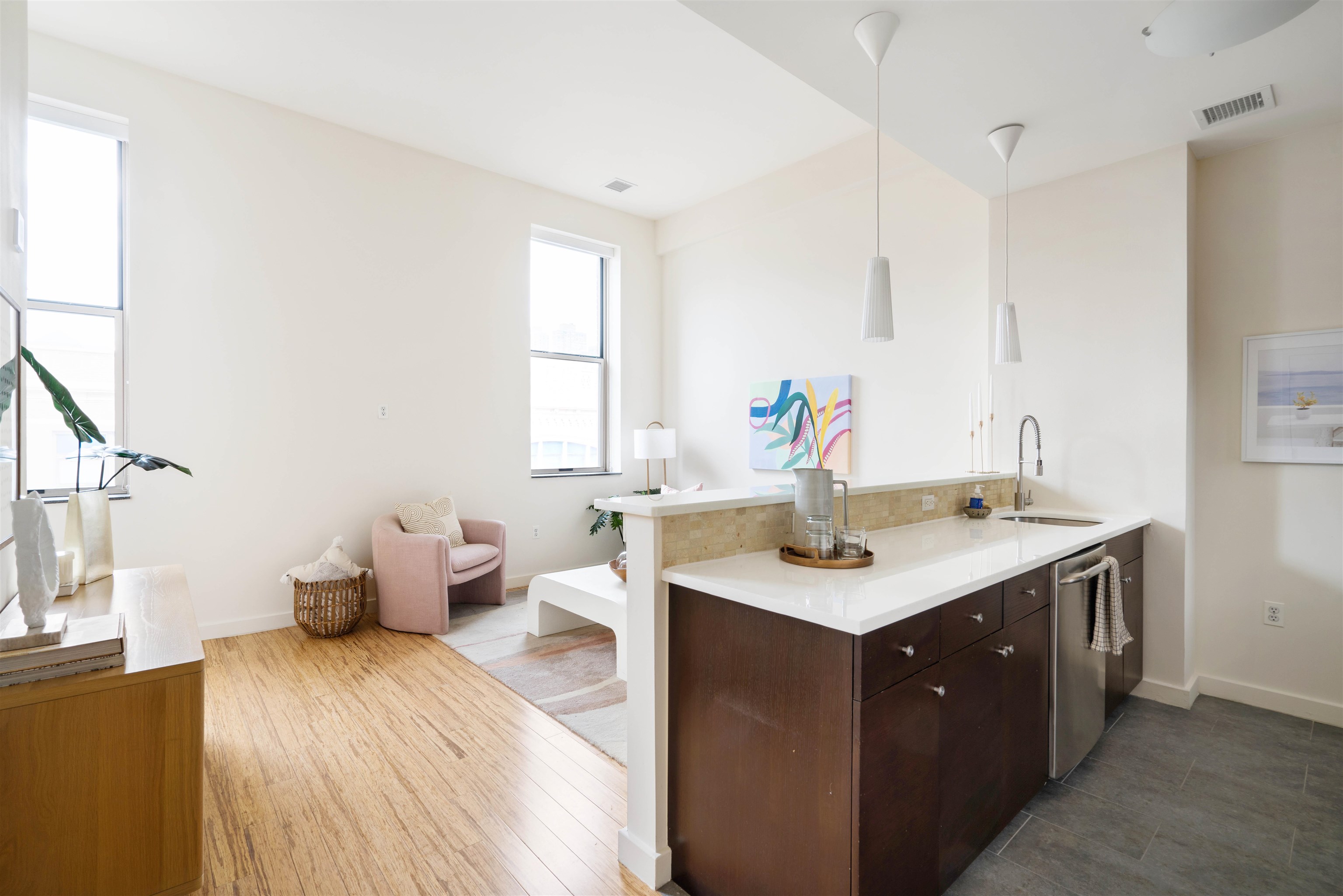 232 Pavonia Avenue, Unit 608 Jersey City, NJ 07302 - Photo 12 of 14 a kitchen with a sink and wooden floor