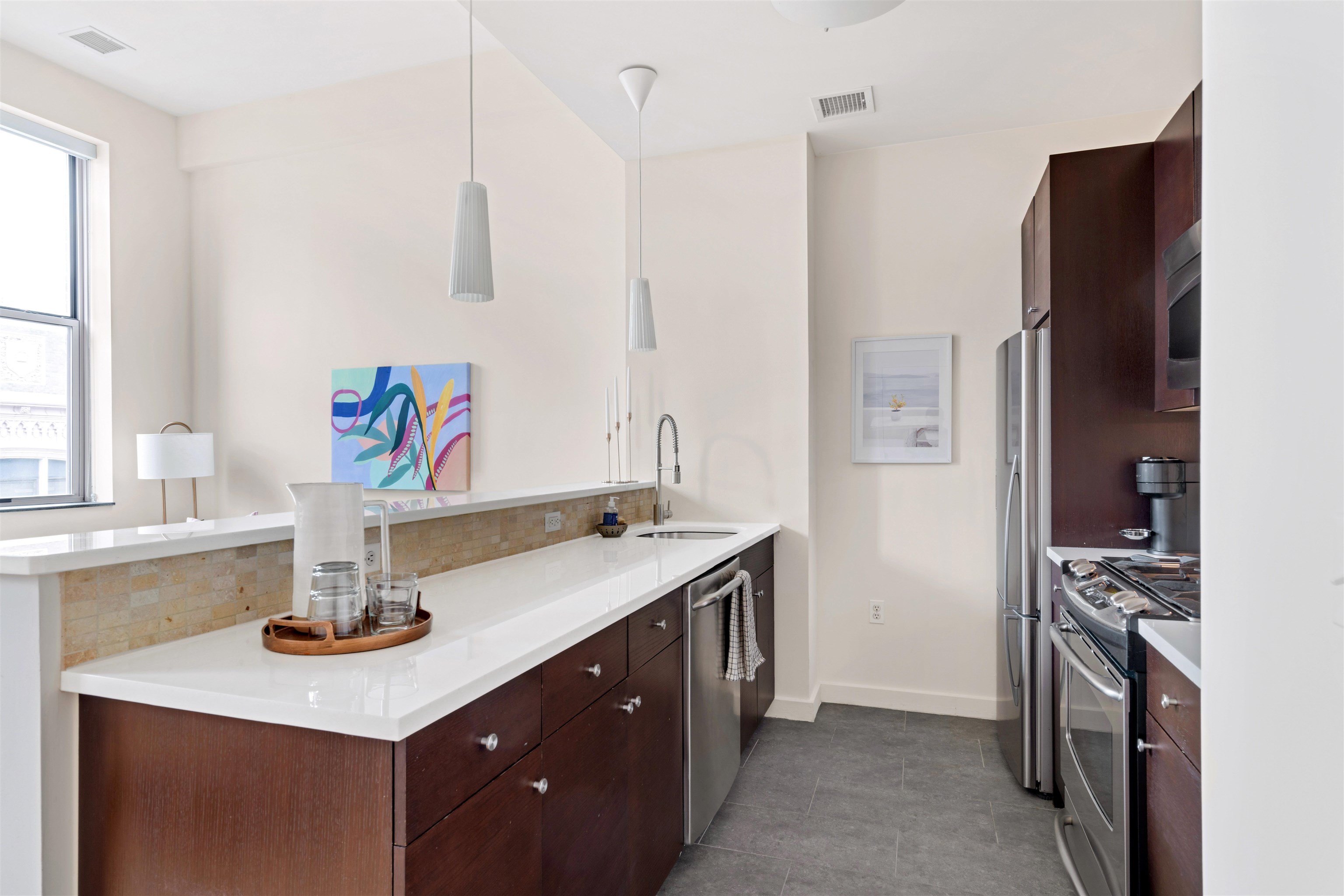 232 Pavonia Avenue, Unit 608 Jersey City, NJ 07302 - Photo 6 of 14 a kitchen with stainless steel appliances a sink stove and refrigerator