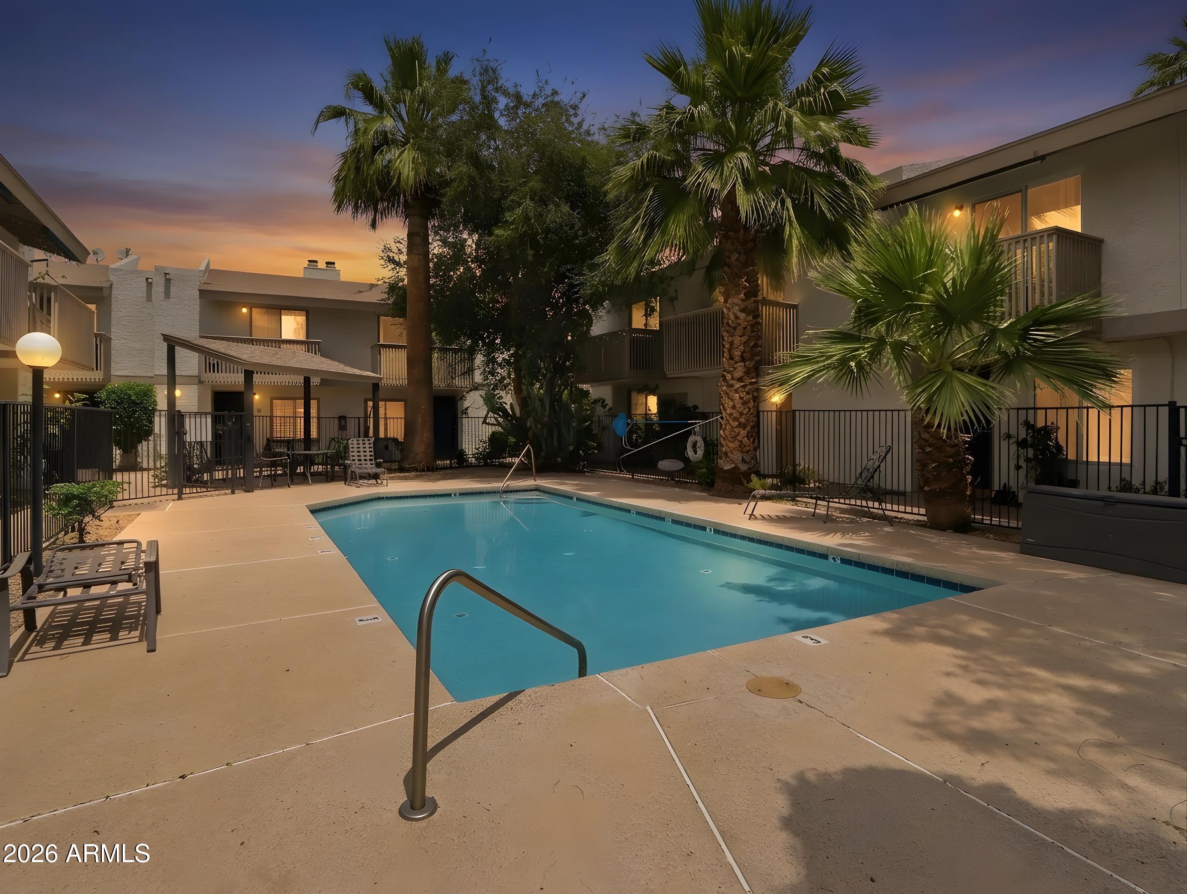 1402 East Osborn Road, Unit 2 Phoenix, AZ 85014 - Photo 26 of 29 a swimming pool with outdoor seating and yard
