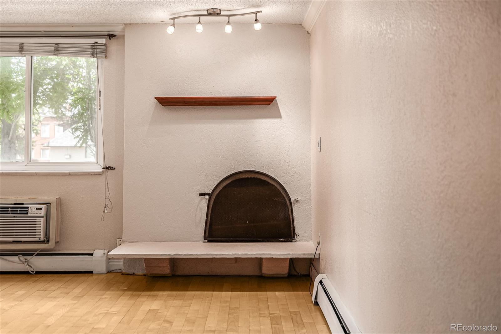 1125 North Washington Street, Unit 207 Denver, CO 80203 - Photo 11 of 33 a living room with a couch and a large window