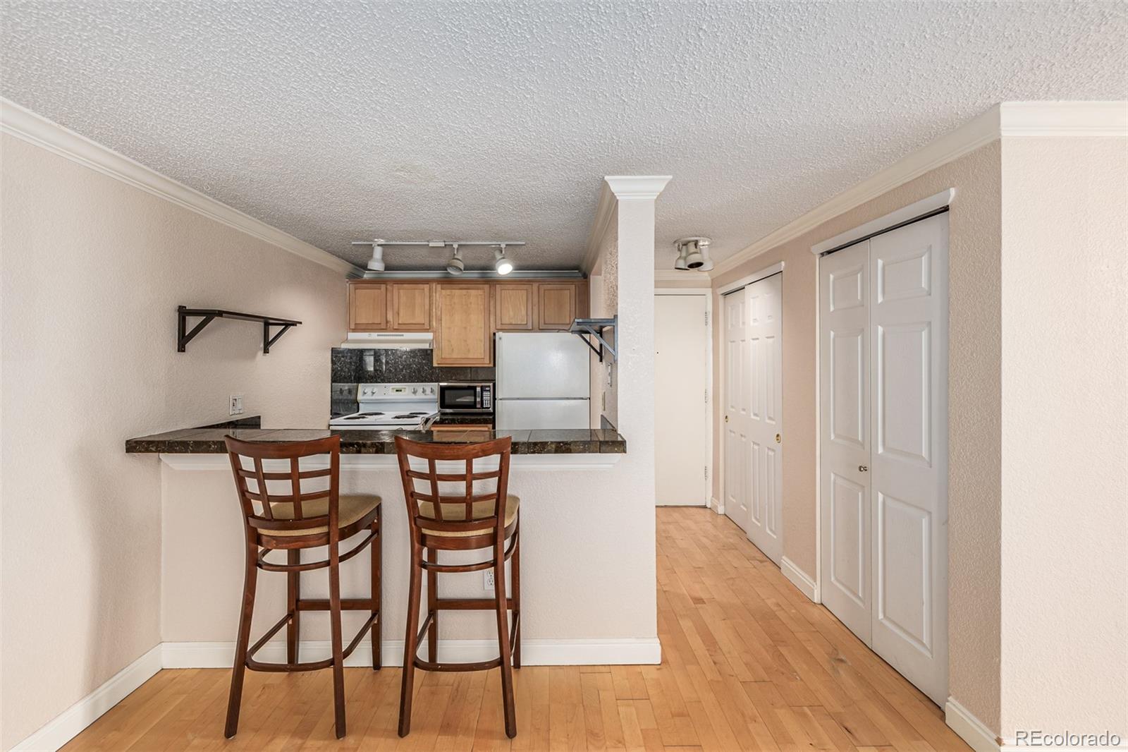 1125 North Washington Street, Unit 207 Denver, CO 80203 - Photo 15 of 33 a kitchen with a table and chairs in it