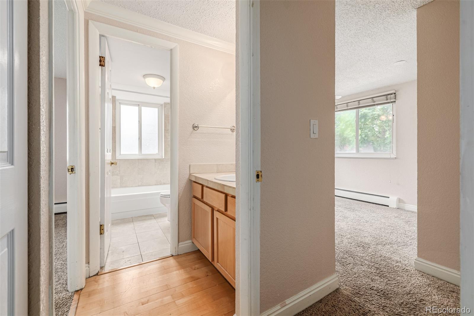 1125 North Washington Street, Unit 207 Denver, CO 80203 - Photo 27 of 33 a view of hallway with wooden floor