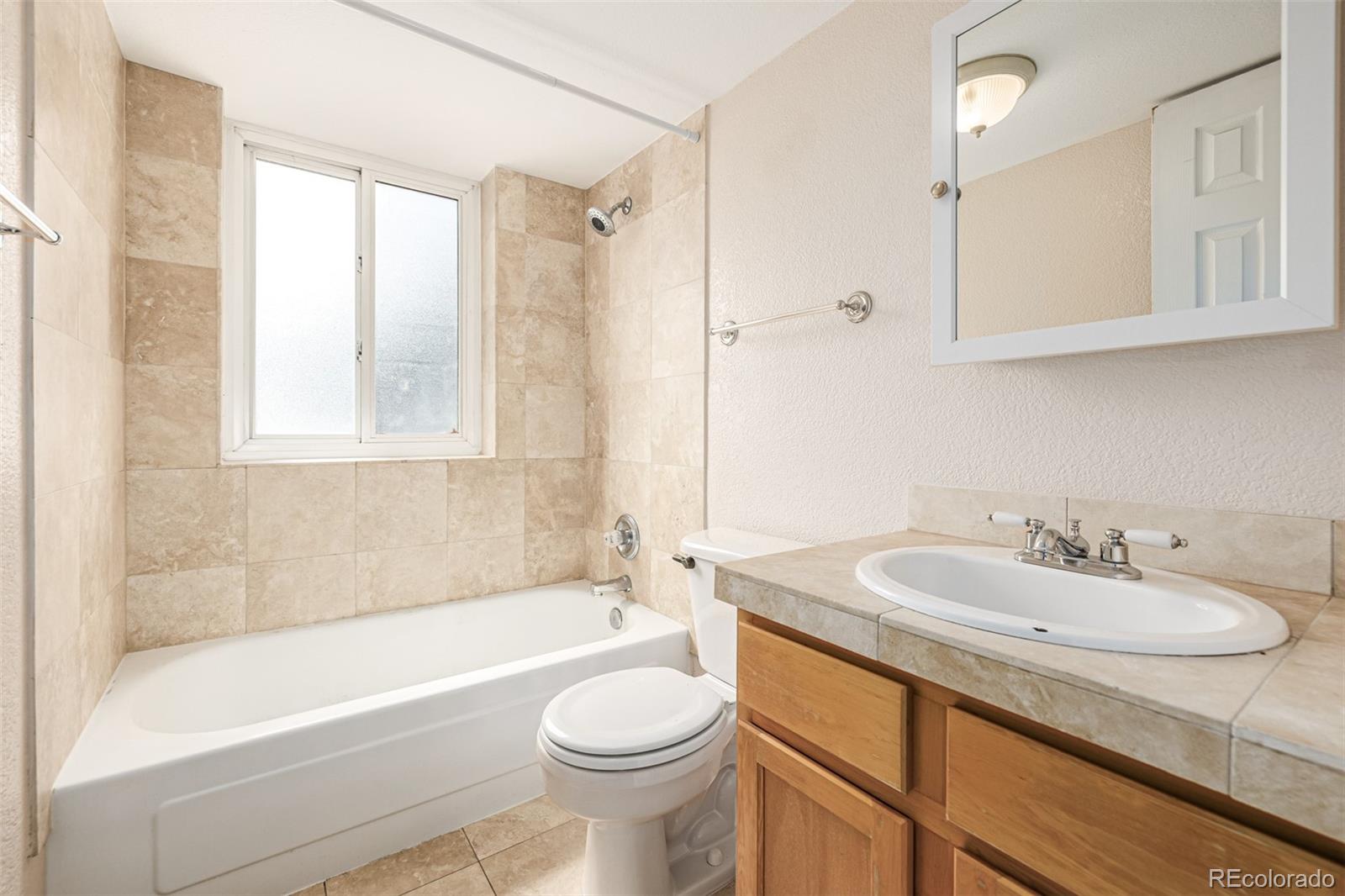 1125 North Washington Street, Unit 207 Denver, CO 80203 - Photo 28 of 33 a bathroom with a sink a toilet and a bathtub