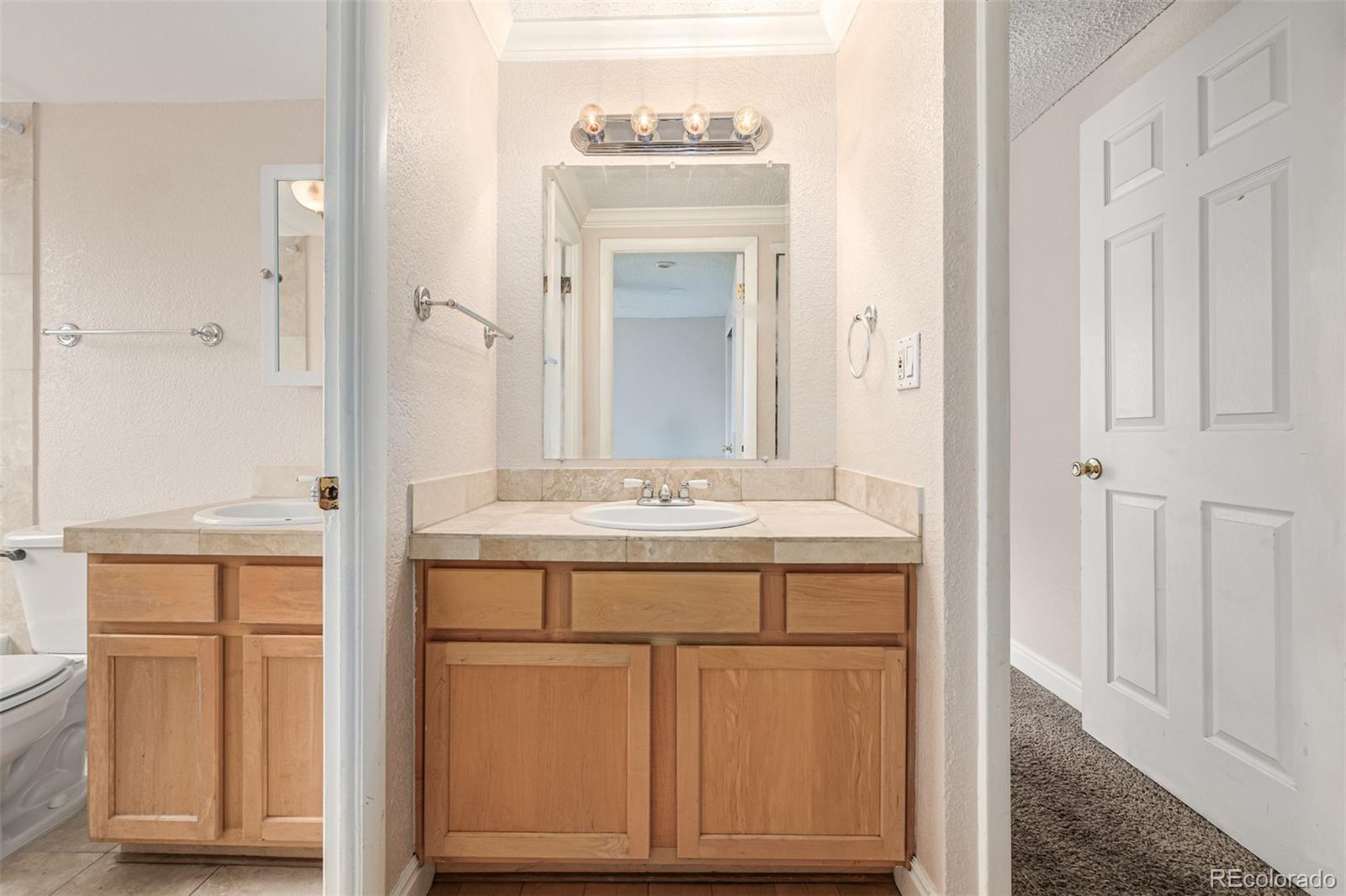 1125 North Washington Street, Unit 207 Denver, CO 80203 - Photo 29 of 33 a bathroom with a sink and a mirror