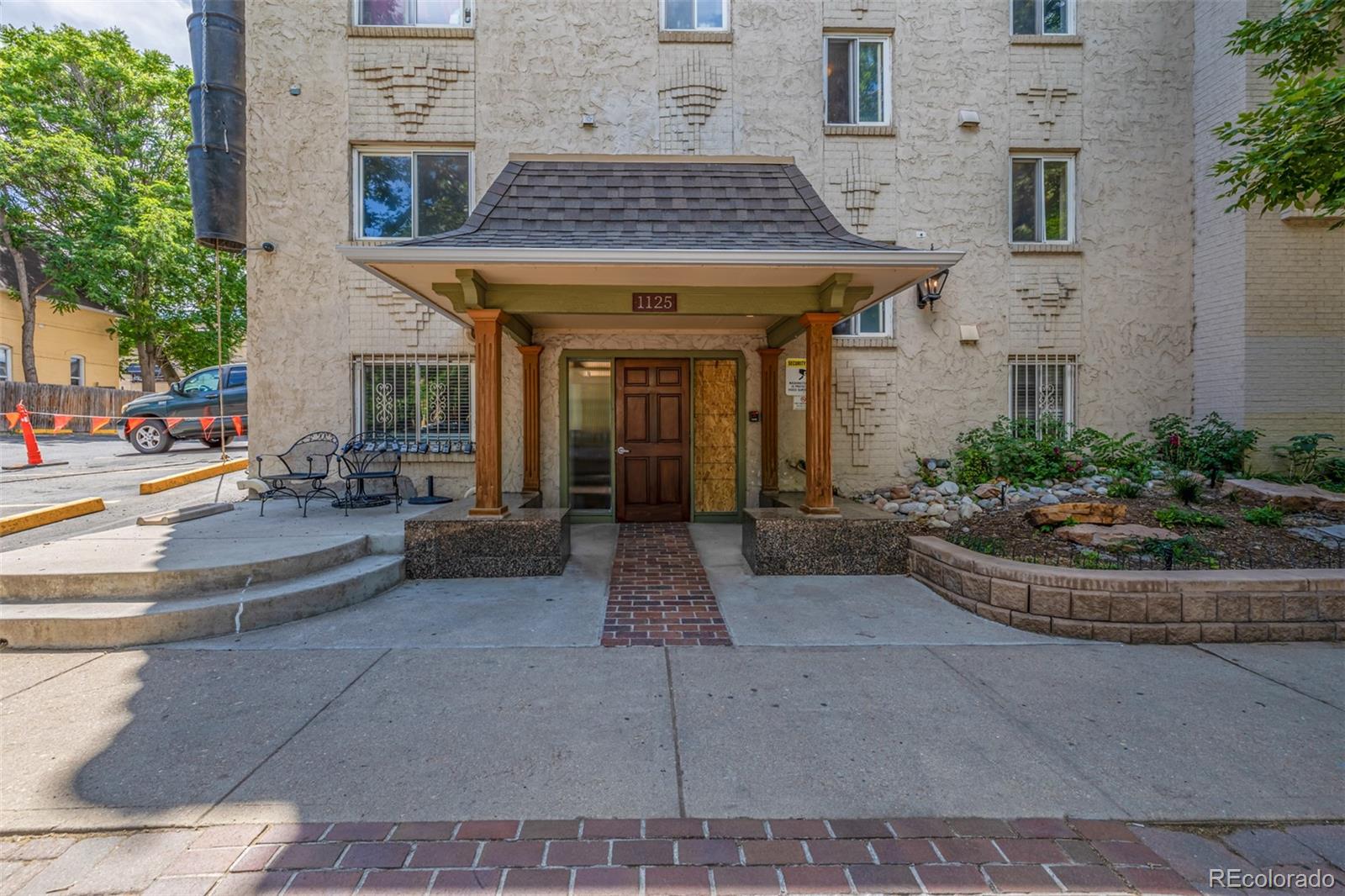 1125 North Washington Street, Unit 207 Denver, CO 80203 - Photo 5 of 33 a view of a building with potted plants