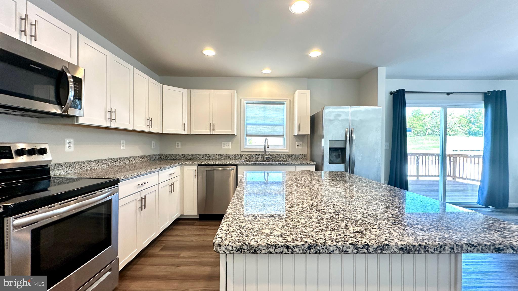 46 Lookover Terrace Stuarts Draft, VA 24477 - Photo 12 of 45 a kitchen with stainless steel appliances granite countertop a stove a sink and a microwave