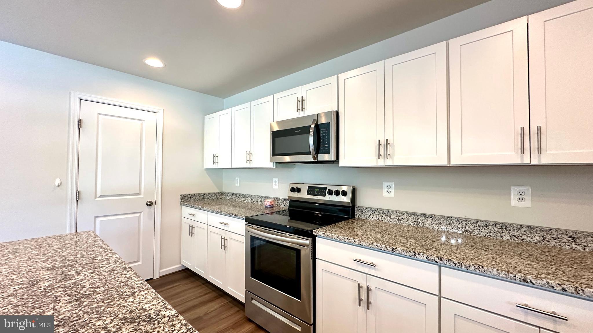 46 Lookover Terrace Stuarts Draft, VA 24477 - Photo 10 of 45 a kitchen with granite countertop white cabinets and stainless steel appliances