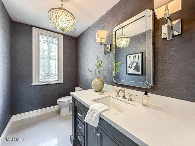 a kitchen with granite countertop a stove and a sink