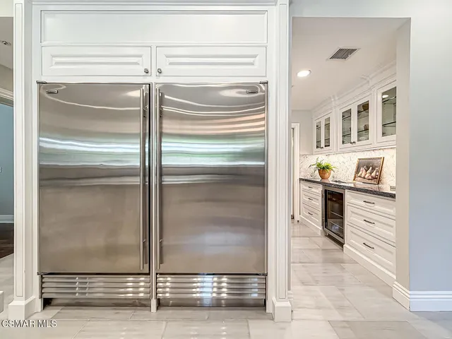 a view of a hallway with wooden floor and windows