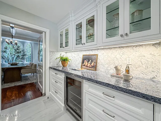a view of an empty room with cabinet and a window
