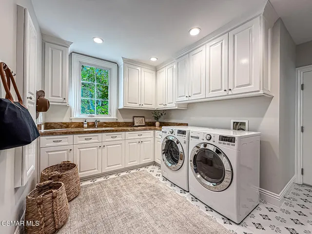 a living room with furniture and a open kitchen view