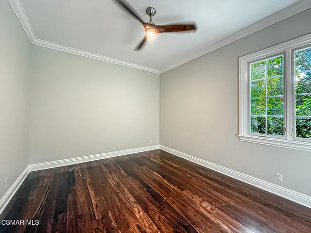 a living room with furniture potted plant and window