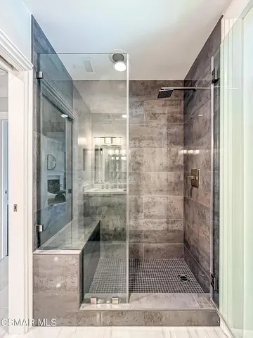 a bathroom with a toilet a sink a mirror a shower a vanity and window