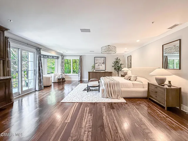 a view of a patio with a table and chairs under an umbrella