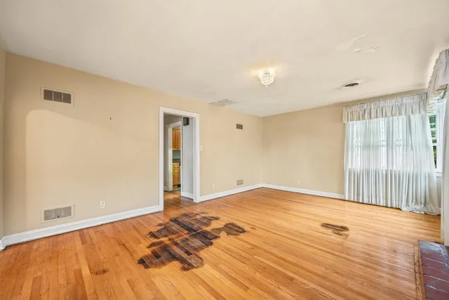 a view of an empty room and wooden floor