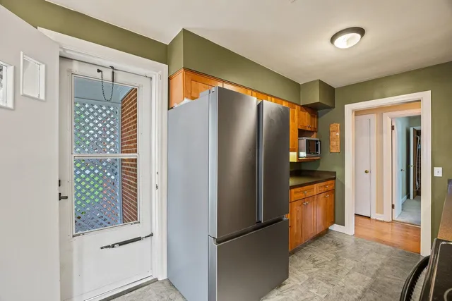 a metallic refrigerator freezer sitting inside of a kitchen