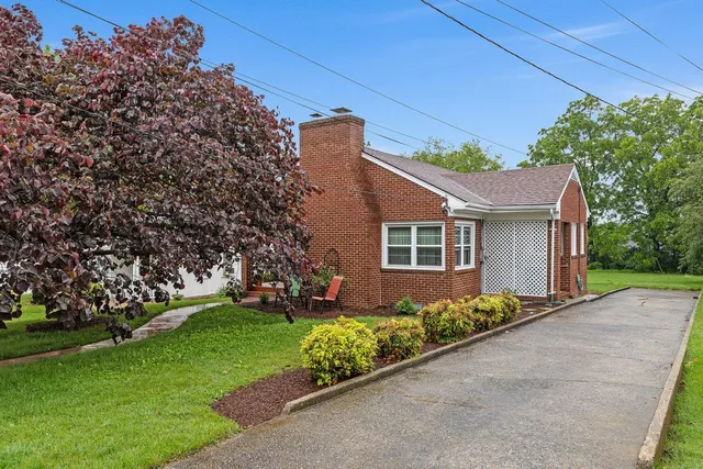 a front view of a house with a garden