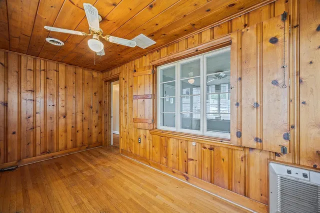 a view of a grassy field with trees